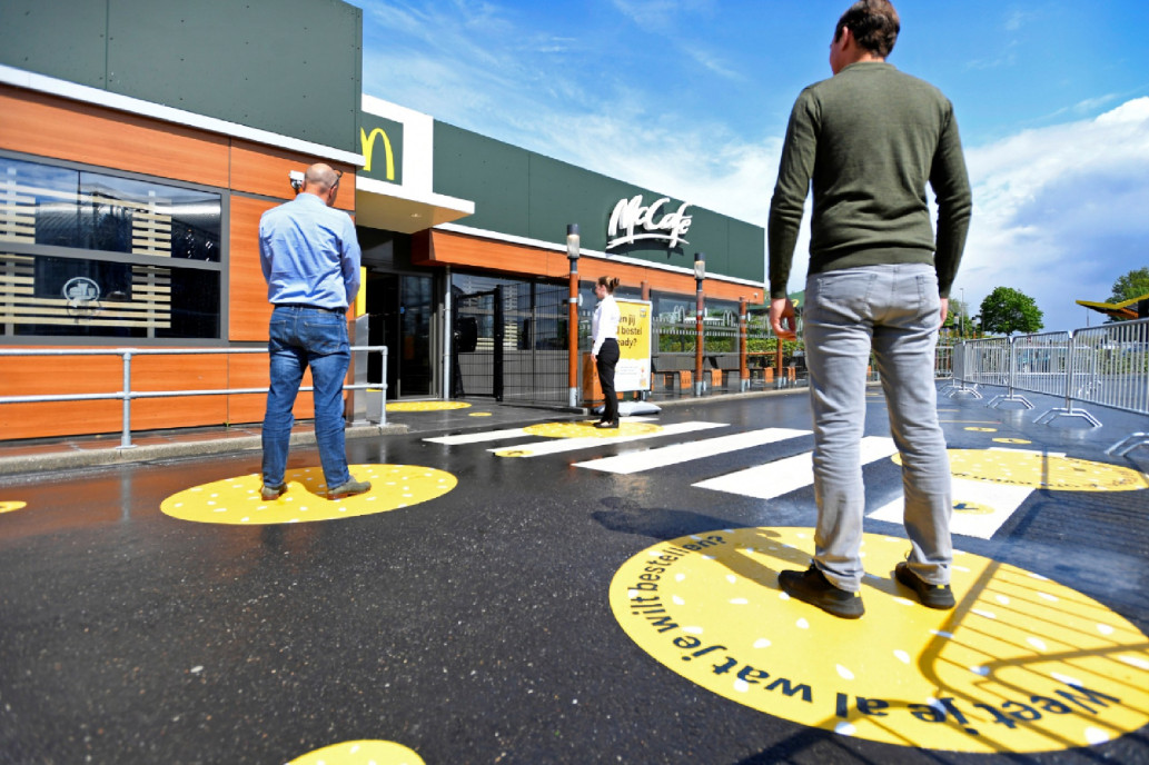 Customers wait outside on social distancing markings at a prototype location of McDonald's in Arnhem, Netherlands. (Reuters)