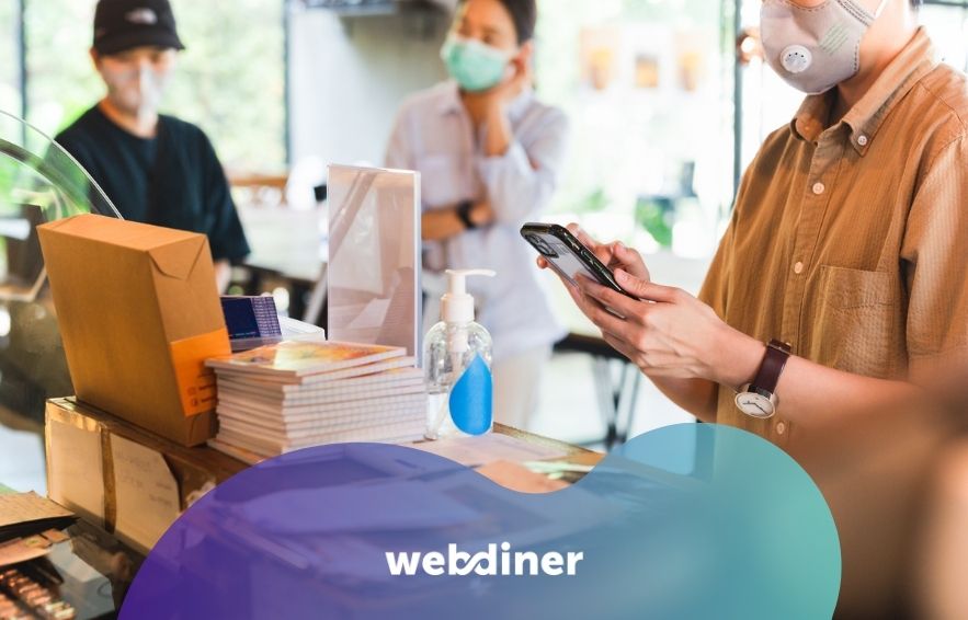 Restaurant Post-Covid Strategies, Women in protective face mask placing an order with cell phone