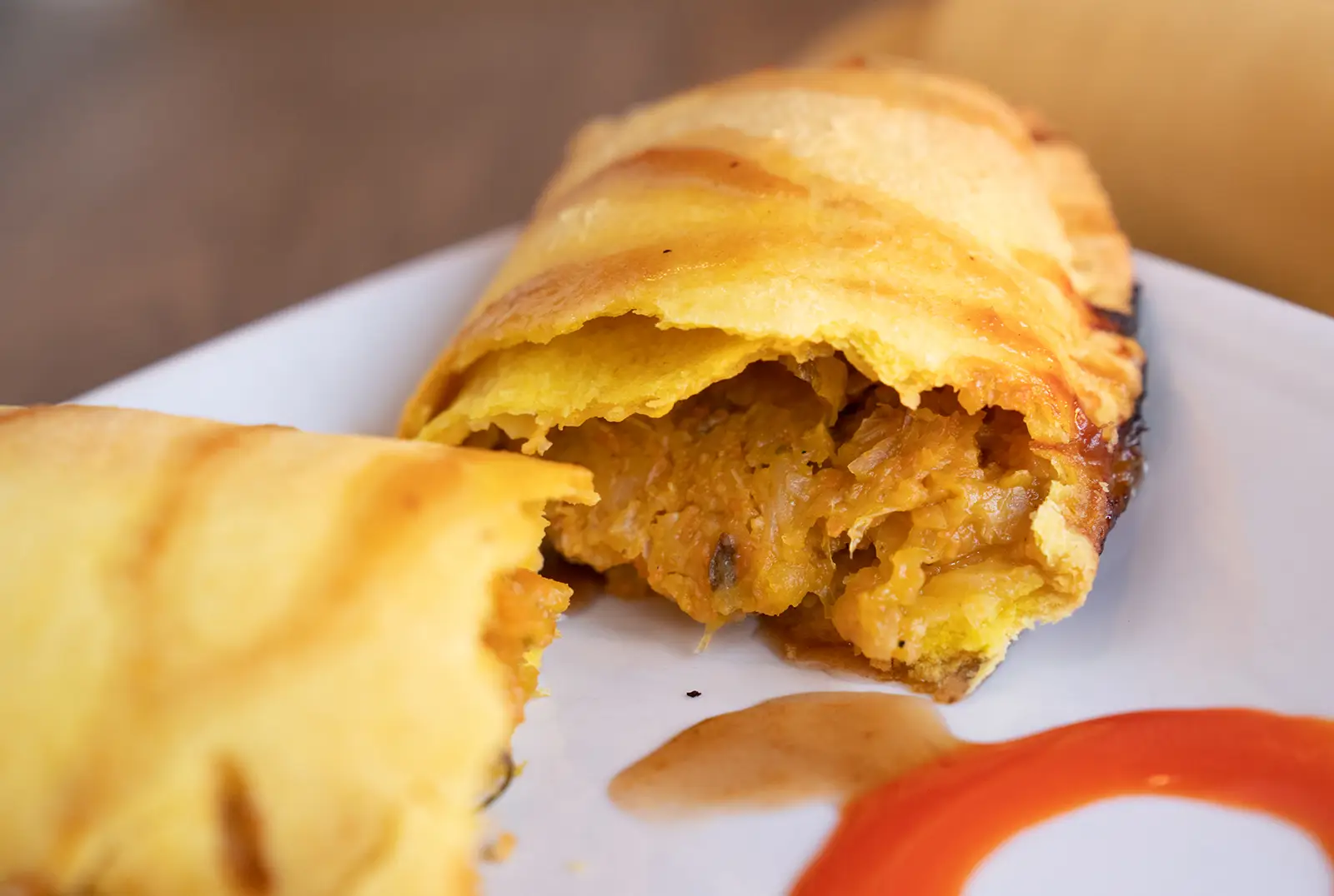 Veggie patty in flaky pastry with spiced cabbage and carrot