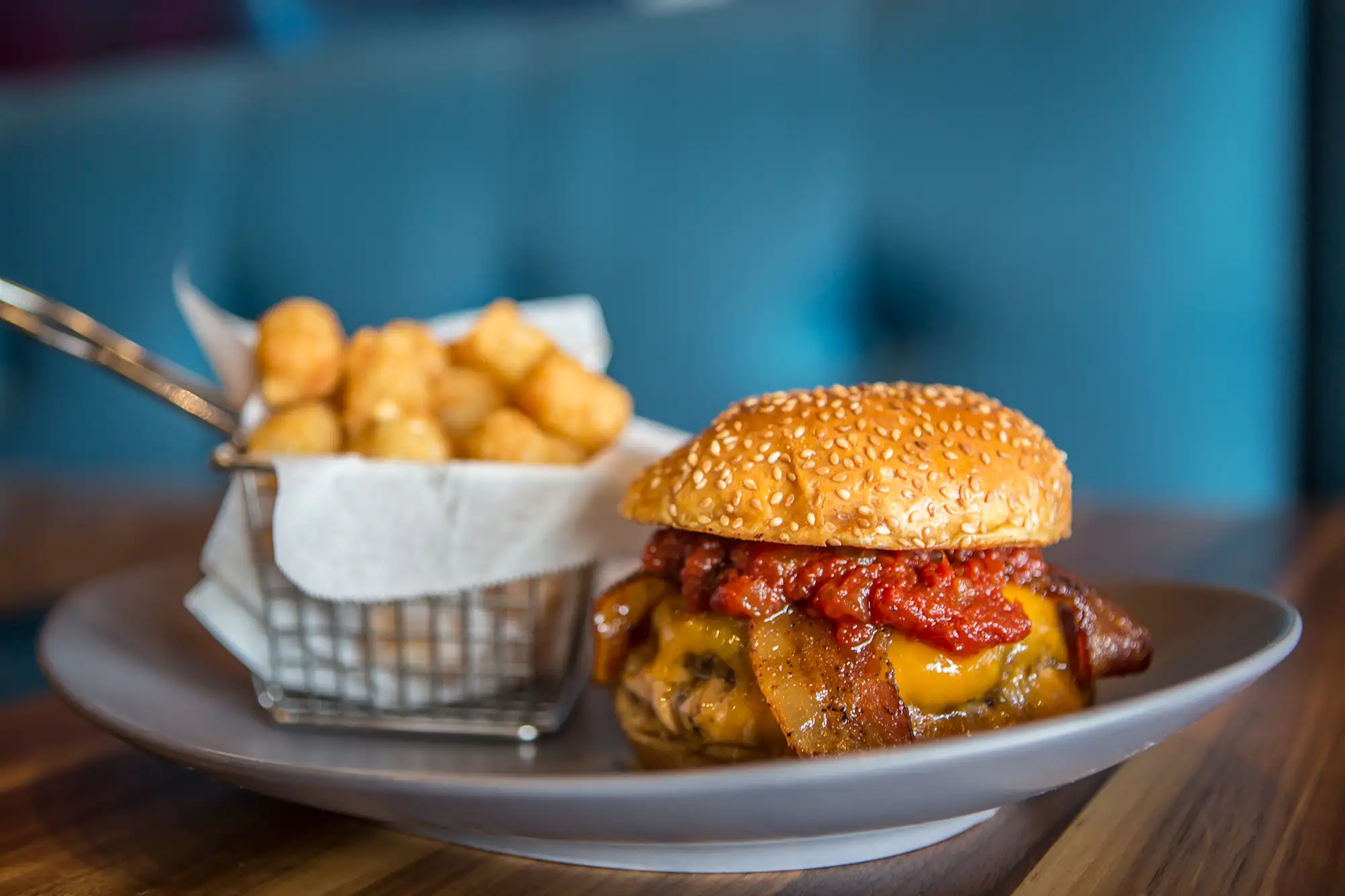 Bacon cheeseburger with a basket of tater tots at BRGR STOP