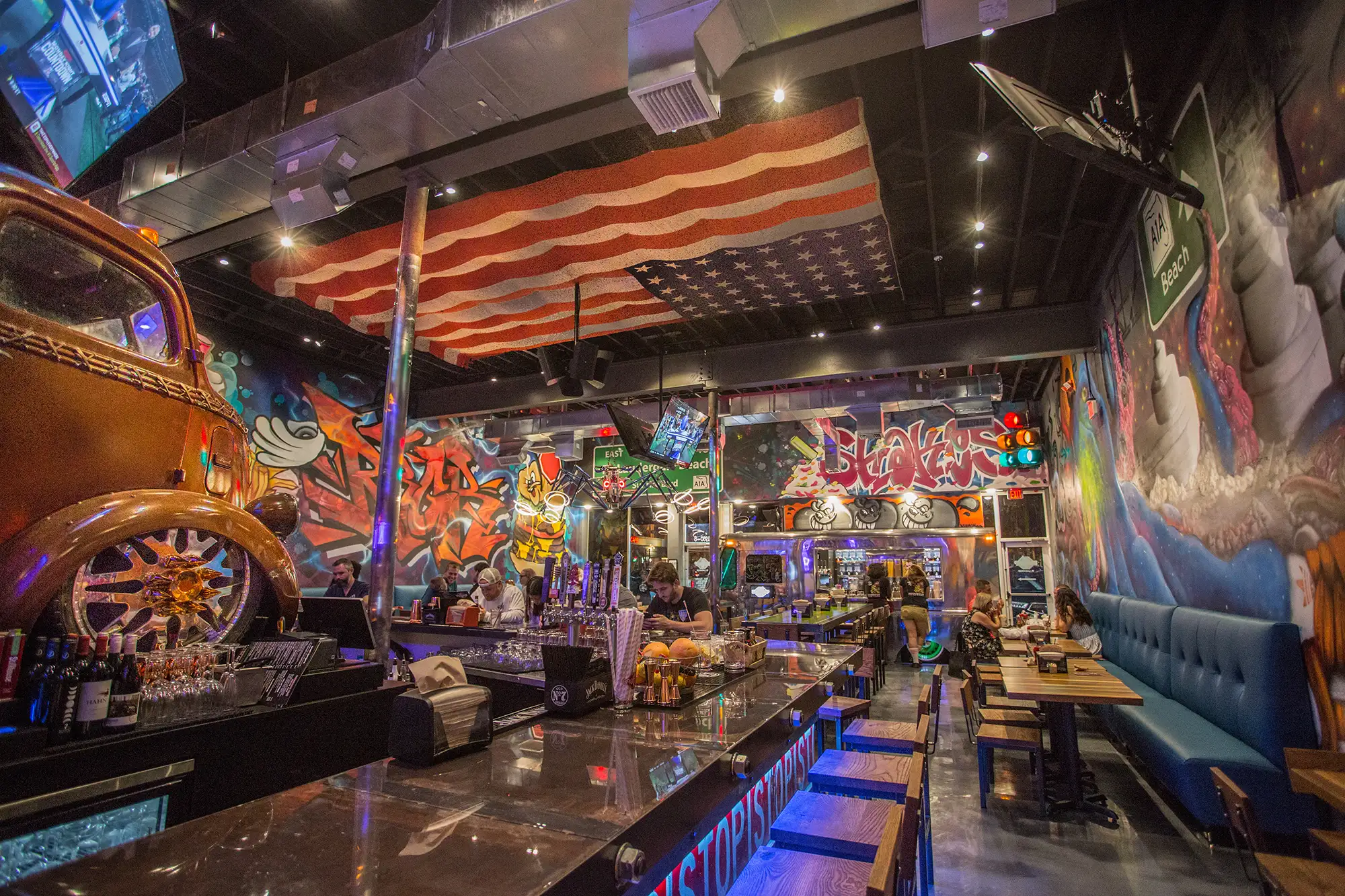 BRGR STOP Ft. Lauderdale dining room with graffiti walls and a lowrider car by the bar