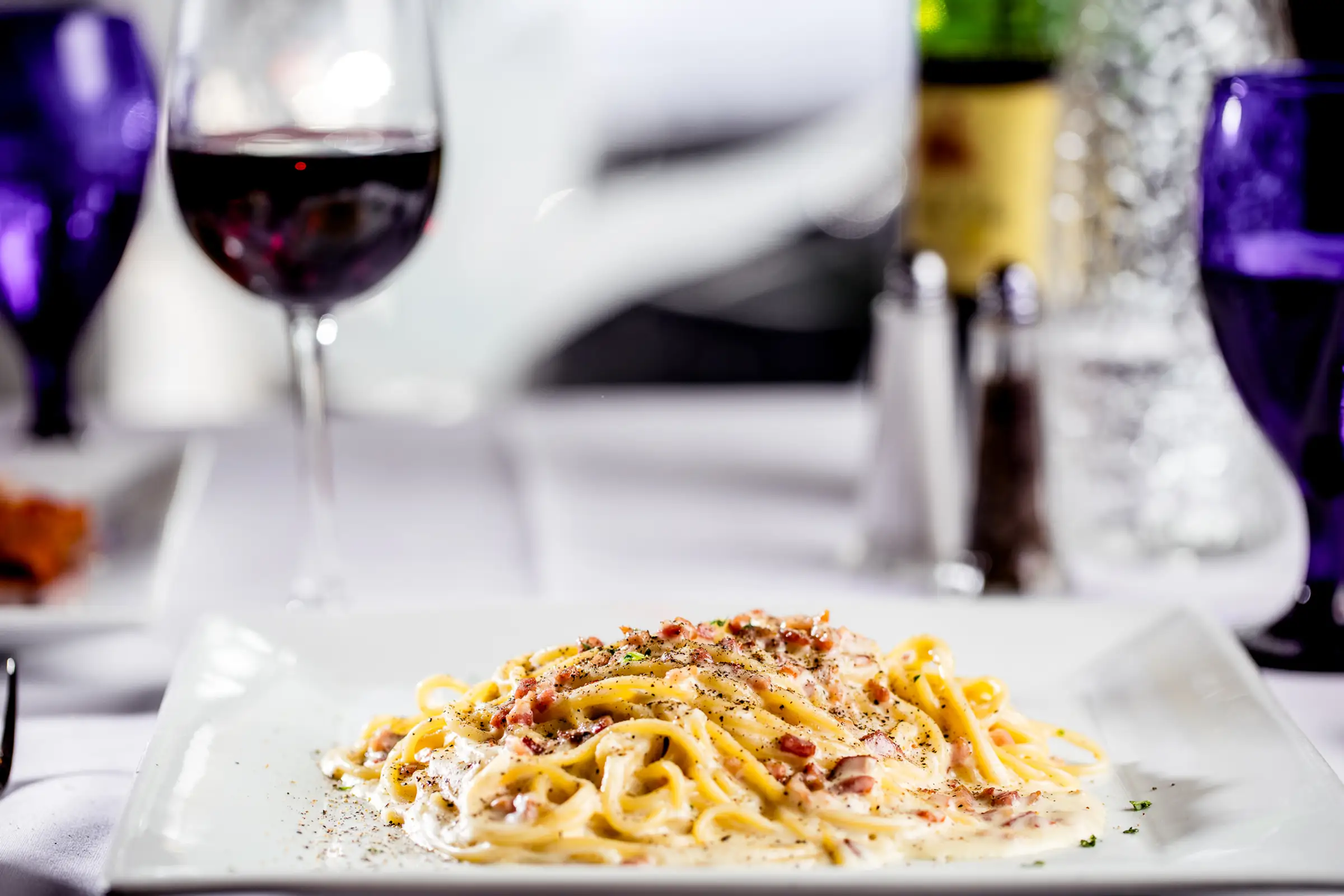 Pasta with a glass of red wine at Capriccio Ristorante