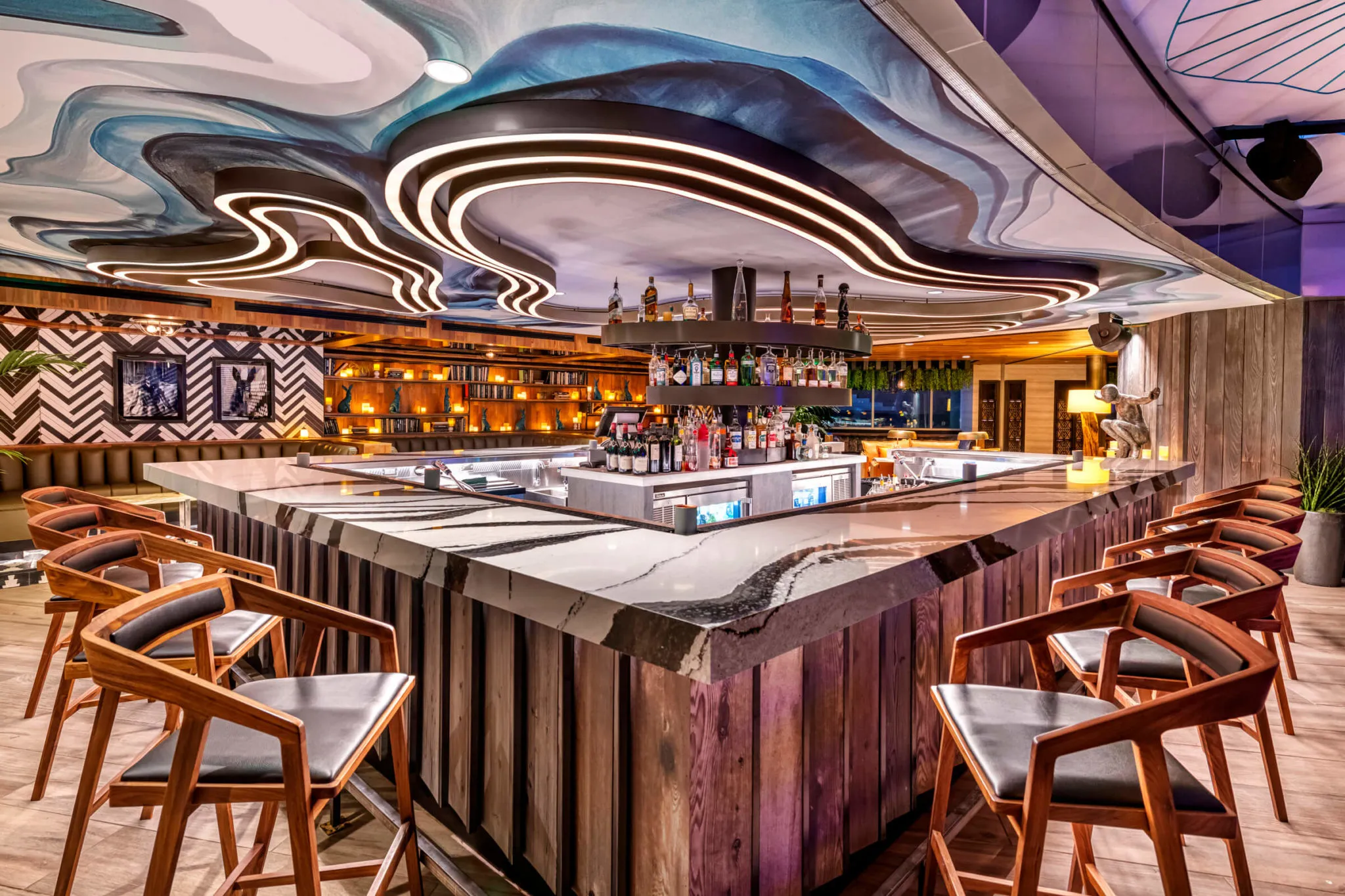 The bar at Cottontail Lounge under its curved light ceiling