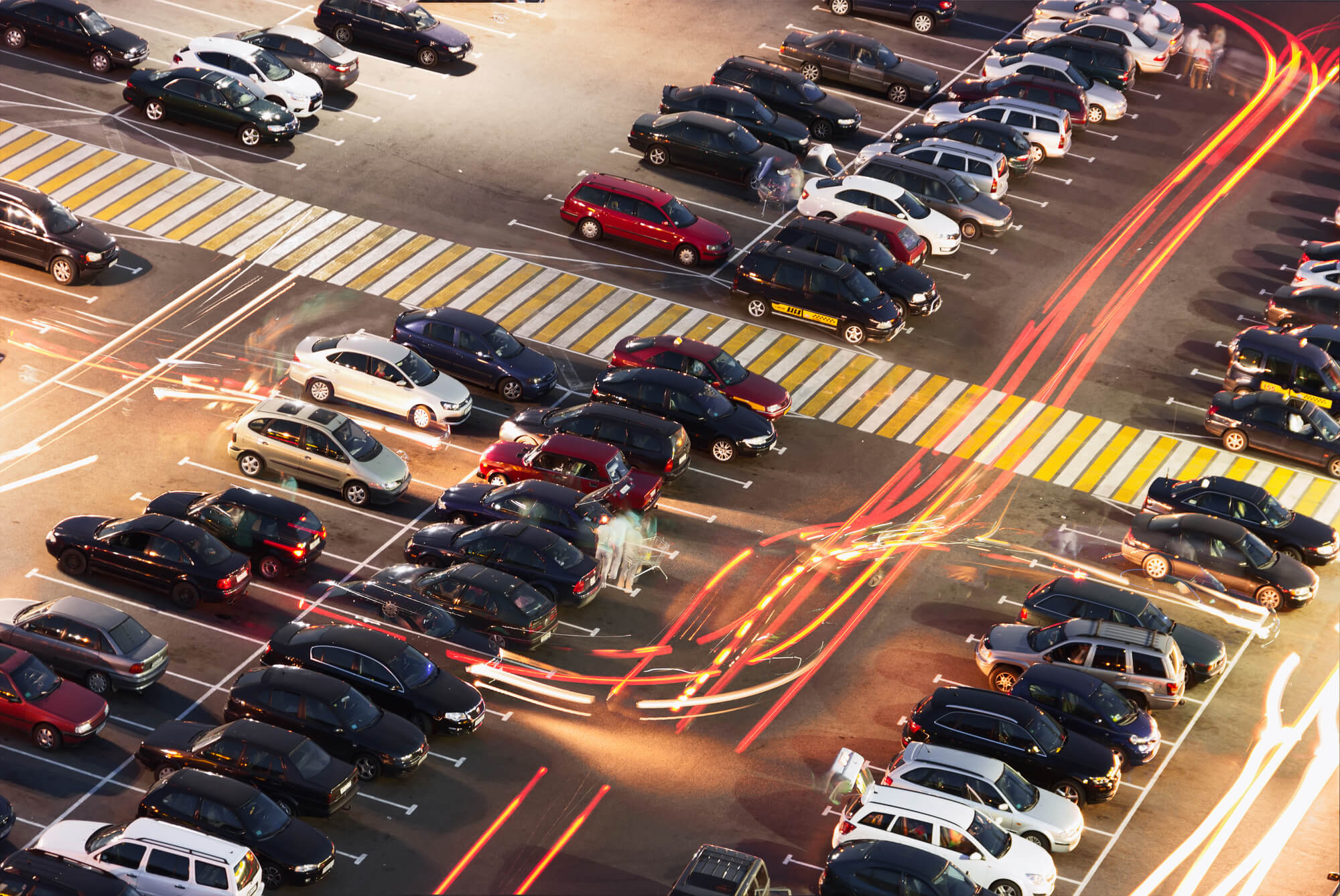 Aerial view of a busy parking lot with light trails