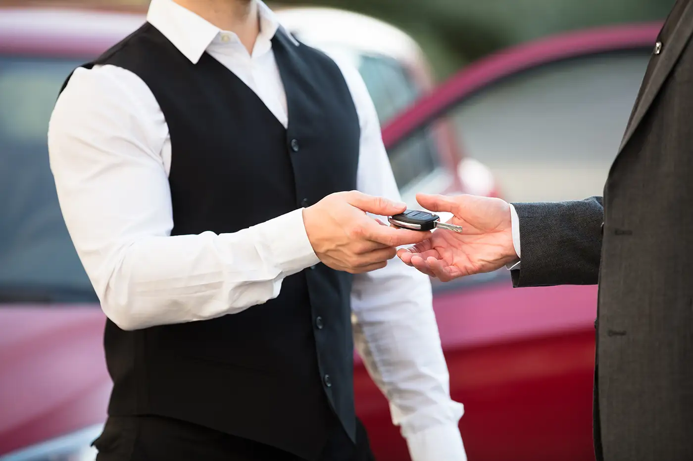 Valet attendant handing car keys to a guest