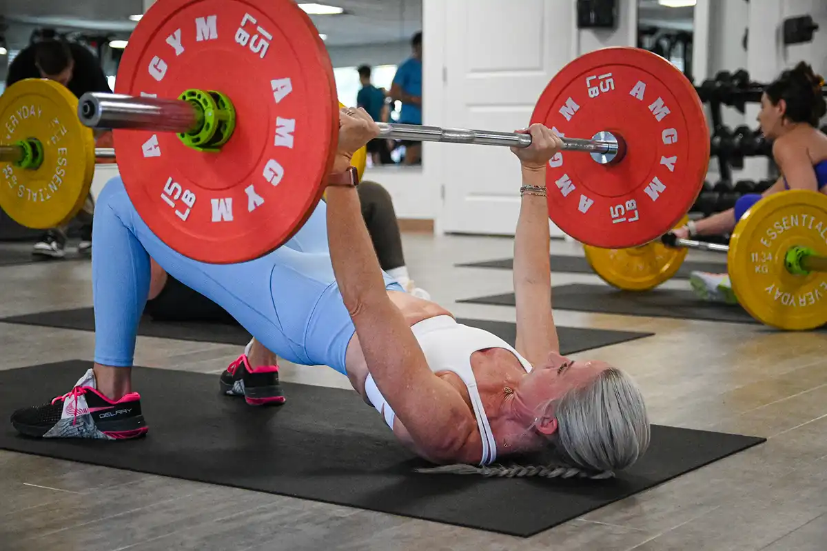 Member doing a barbell glute bridge at JustLIFT