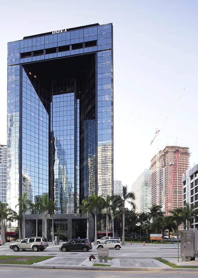 Glass office tower with a parking entrance
