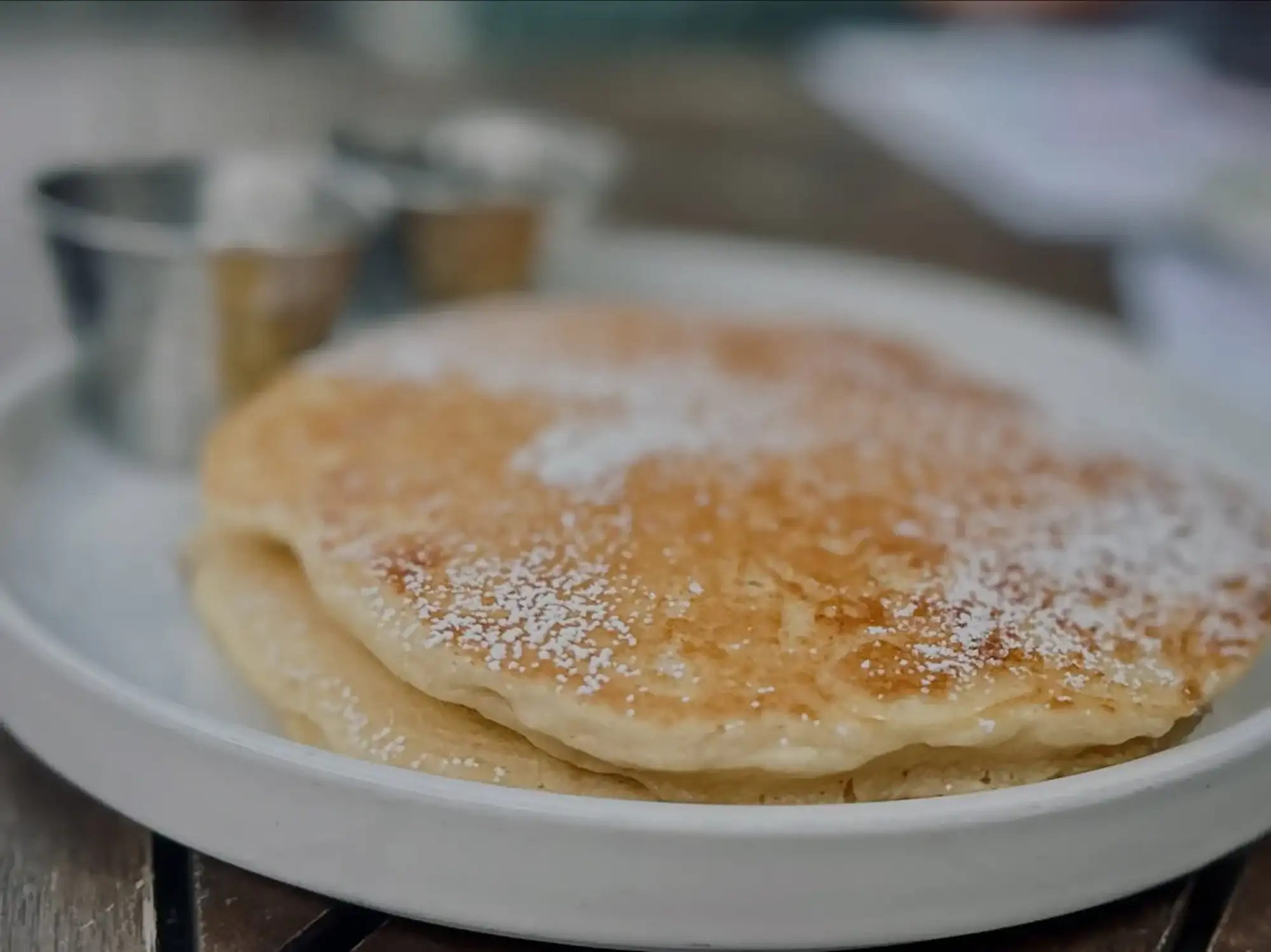 Buttermilk pancakes dusted with powdered sugar at Scratchboard Kitchen