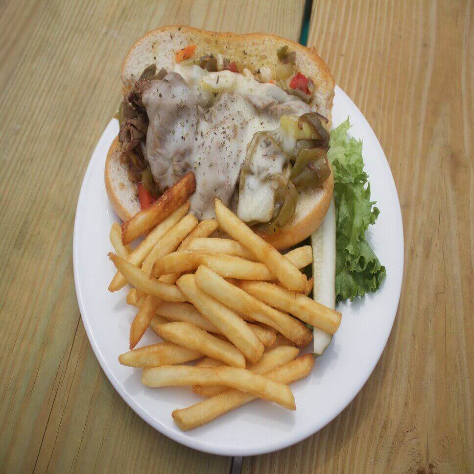 Beef sandwich with peppers, melted cheese and fries at MATEYS